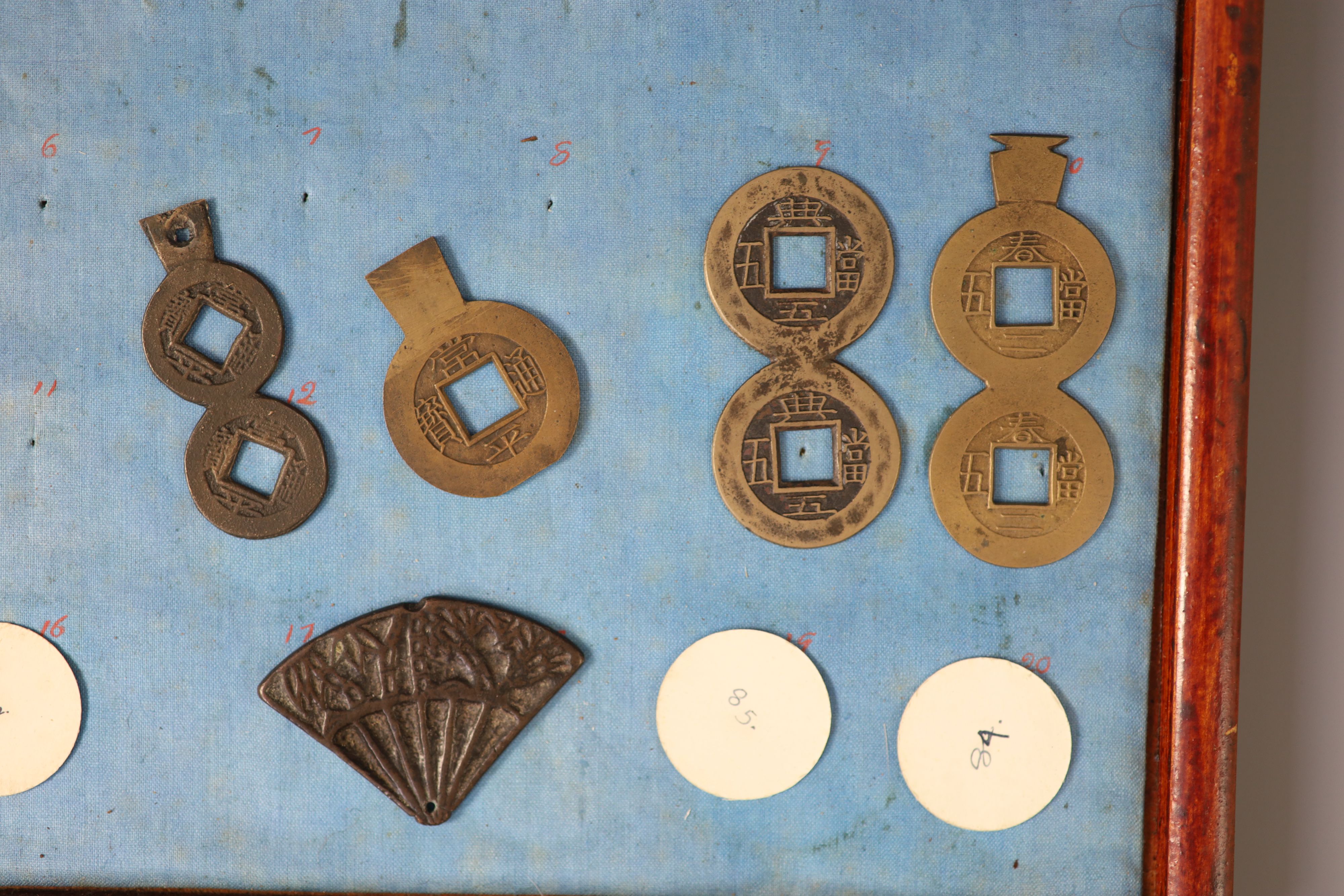 A group of 99 Korean bronze and metal amulets or charms, 19th/20th century